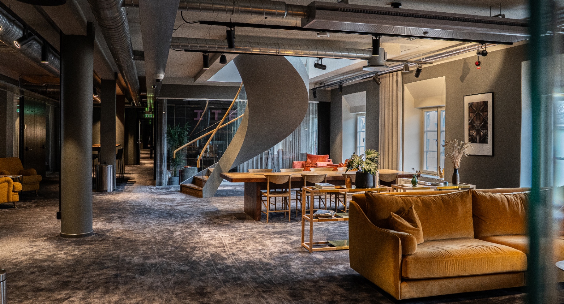 Lounge med spiraltrappa och varm belysning